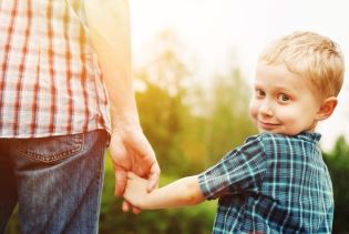 Young Boy Holding Parent Hand